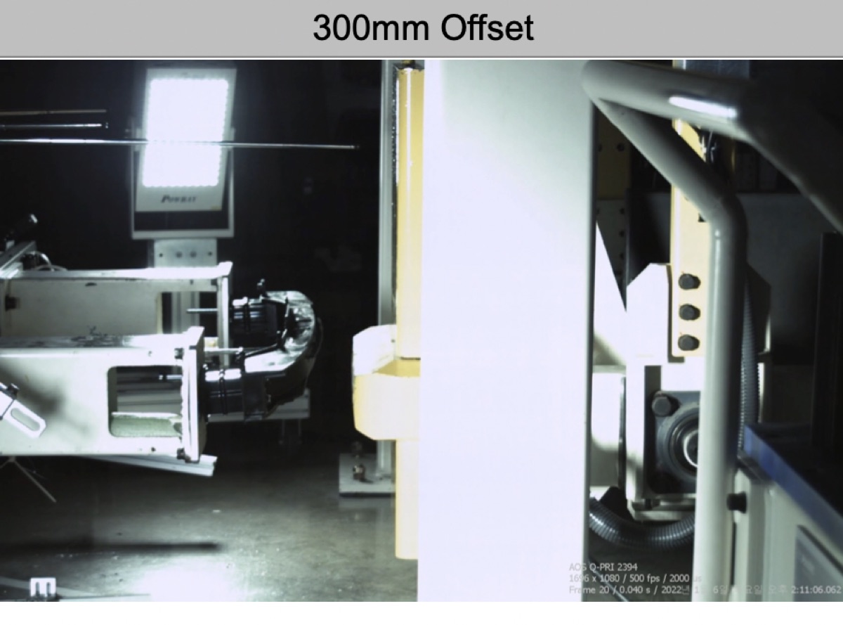 A high-speed camera frame of a 300 mm offset impact test rig striking a composite bumper beam