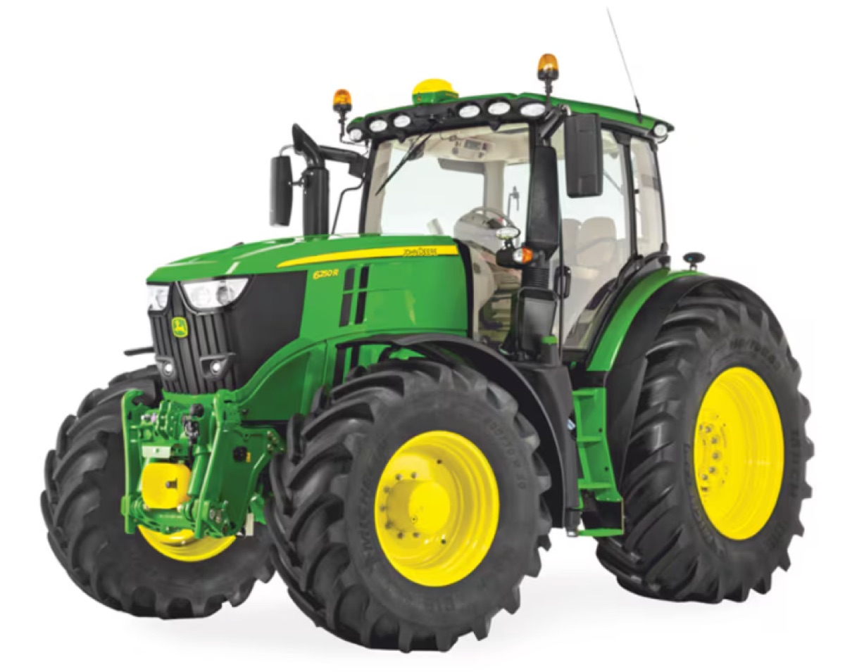A green agricultural tractor with a moulded bonnet and fenders, photographed on white