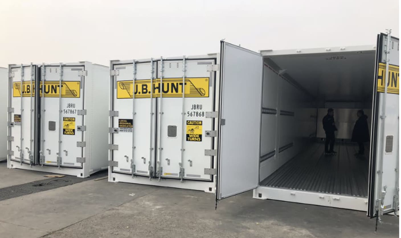 A row of 53-foot J.B. Hunt intermodal containers, one with its doors open
