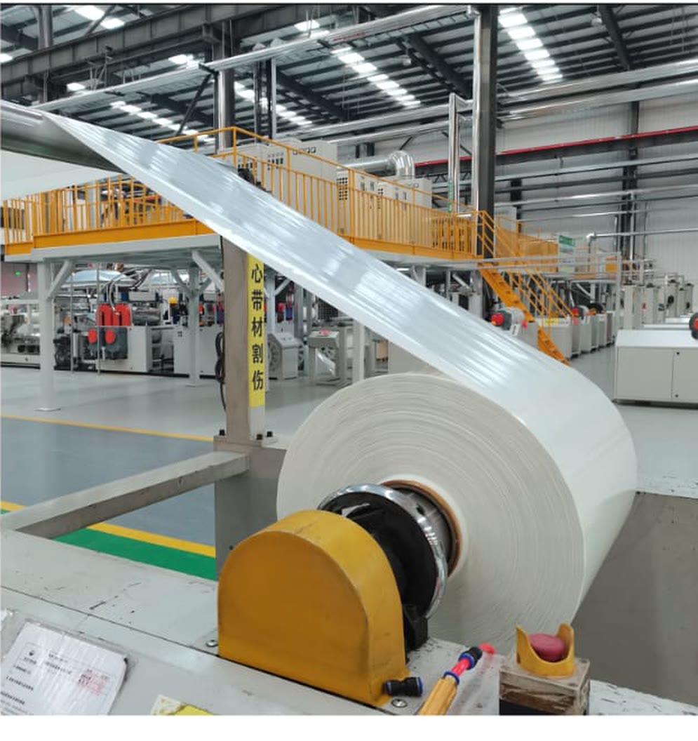 A large roll of unidirectional glass-fibre tape being wound on the production line