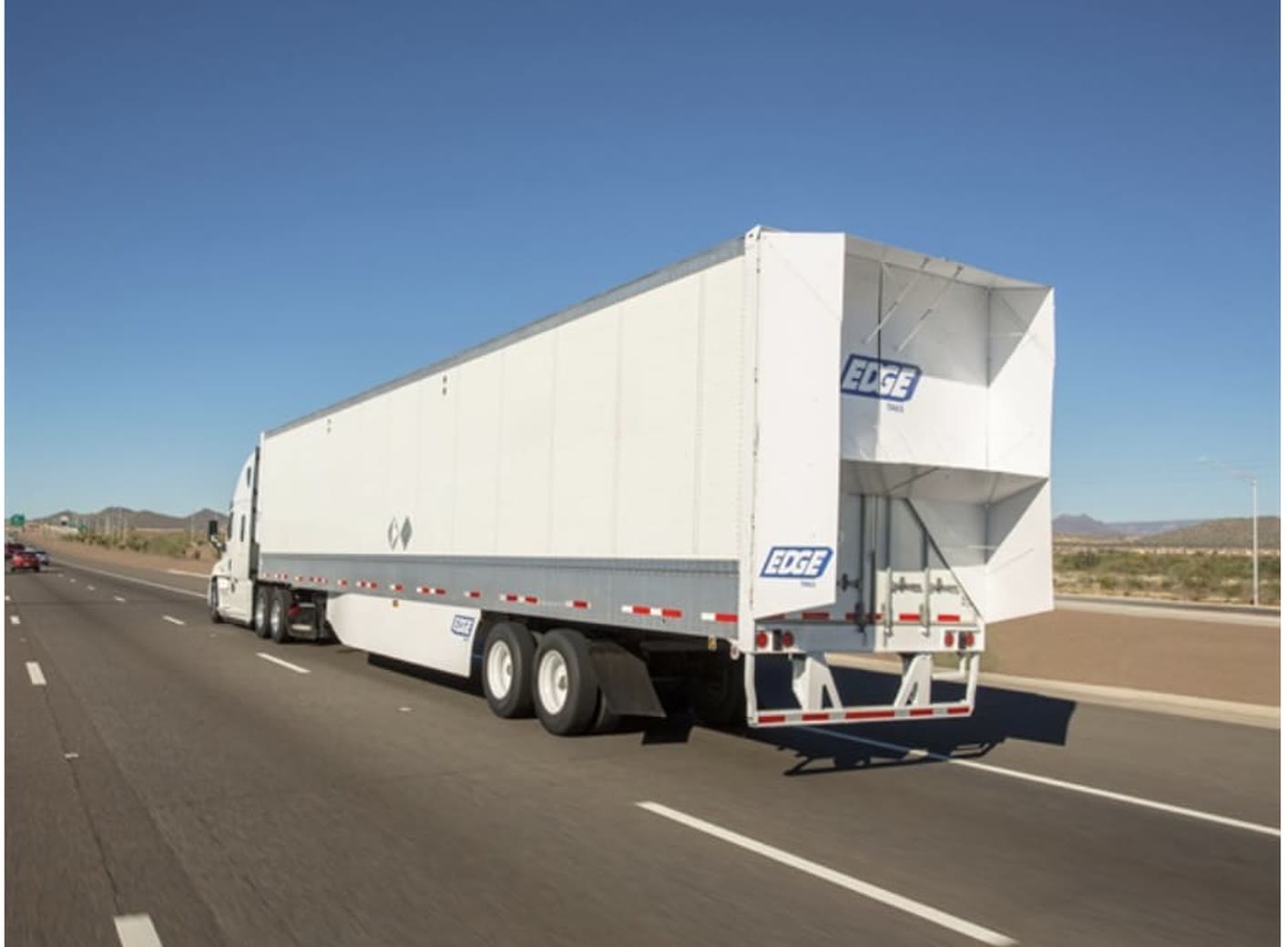 A refrigerated highway trailer travelling a desert road